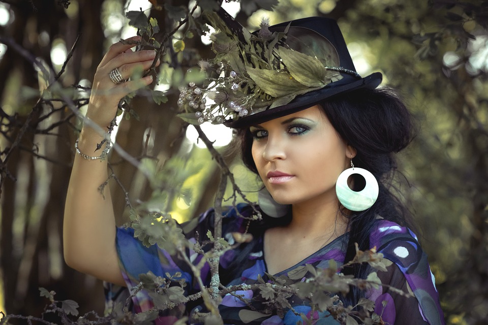 woman with black hat on the woods
