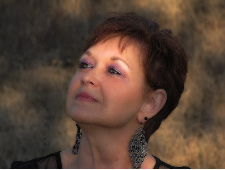 a lady with a makeup and large earings